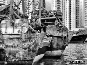 "I went on a boat cruise in Hong Kong and I thought it will be a great fit for my 'People at Work' collection and I liked the juxtaposition of old, rusty fishing boats and the cosmopolitan city just right behind it "