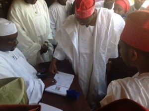 Governor Rabiu Kwankwaso of Kano State registers amidst his supporters.