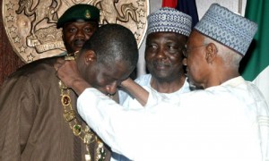 Shehu Shagari decorating current President, Goodluck Jonathan with Nigeria's highest honour, the Grand Commander of the Federal Republic, GCFR.