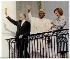 President Carter, Shehu Shagari and Mrs. Carter greeting cheering crowds from the White House balcony in 1980